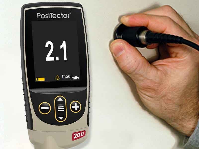 PosiTector 200 B1 measuring combined paint and primer thickness on drywall