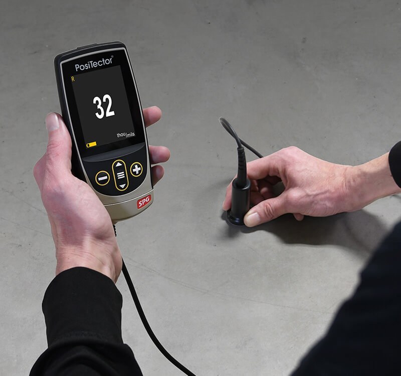 PosiTector SPG TS measuring concrete surface profile on a concrete slab